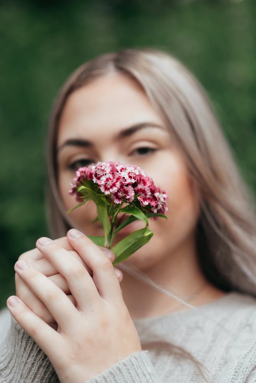 female smelling fresh flowers turkish carnation